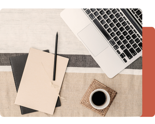 A laptop sits atop a textured desk, accompanied by a notebook, a black pen, and a cup of coffee on a woven coaster. A laptop sits atop a textured desk, accompanied by a notebook, a black pen, and a cup of coffee on a woven coaster.